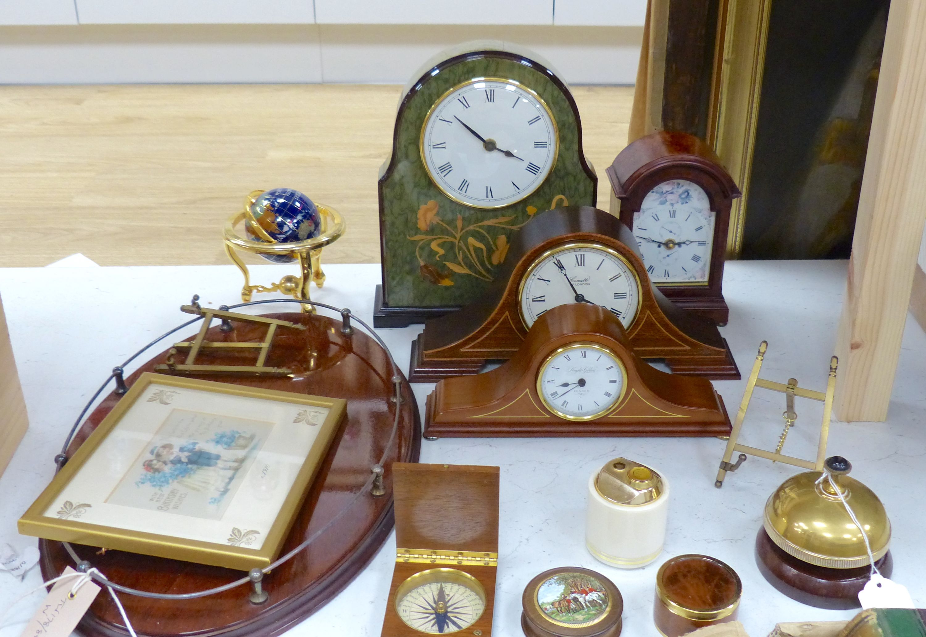 Miscellaneous items, including a brass counter bell, an oval inlaid mahogany galleried tray and four various mantel clocks